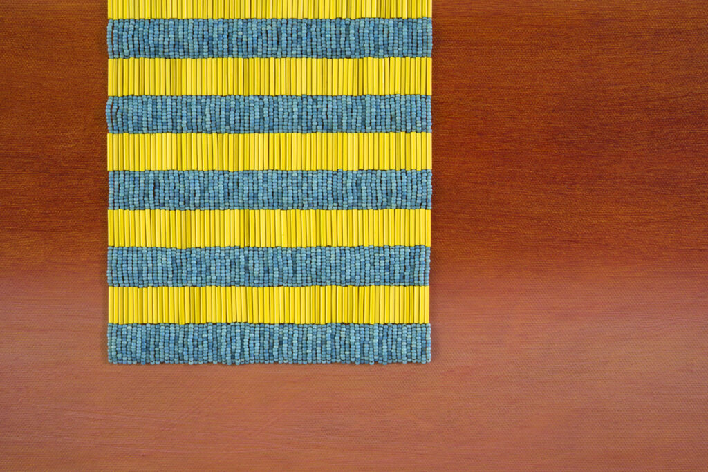 Detail of painting: rectangle with beaded yellow and turquoise stripes, against lighter and darker coral stripes.