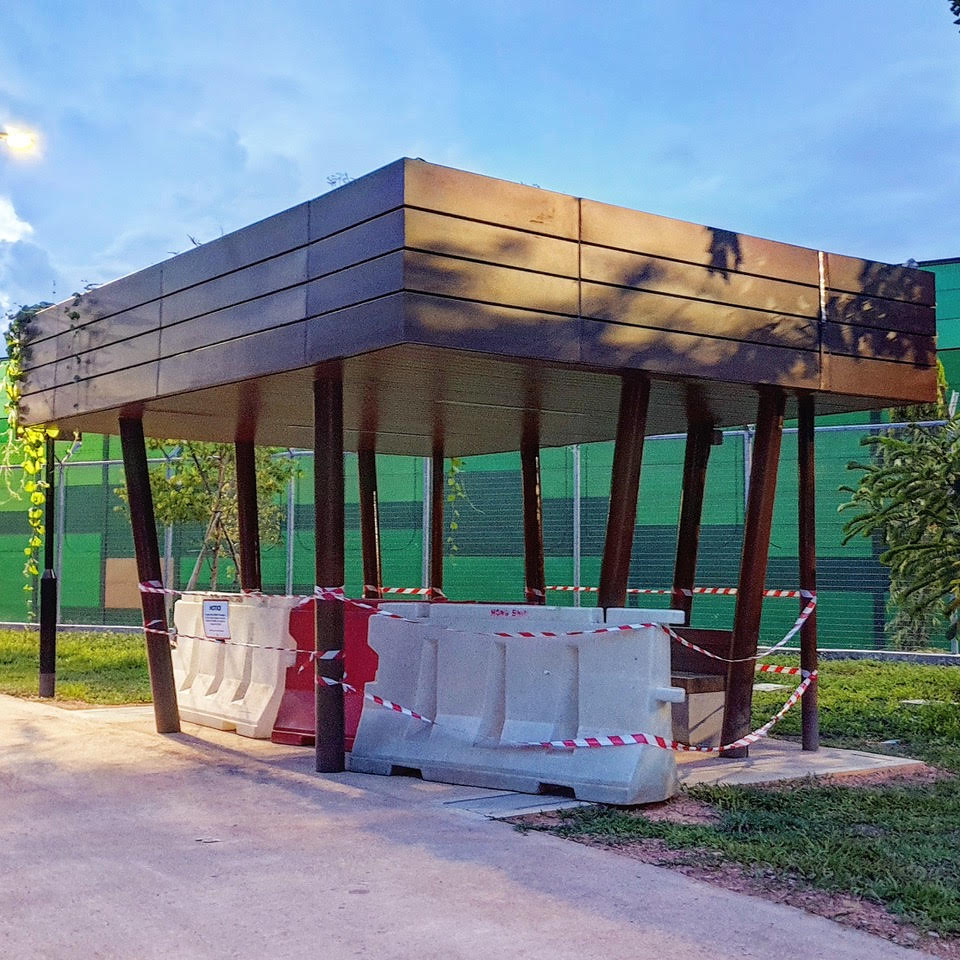 An outdoor sitting area is roped off with plastic barricades and tape/string