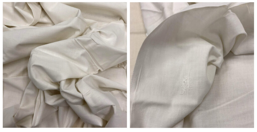 Loosely folded off-white textile.