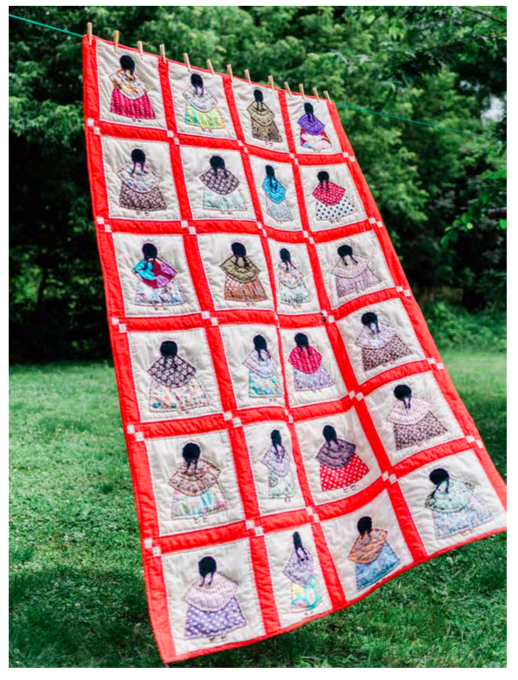 Quilt hangs on clothesline, with red-outlined squares and in each one, back of a figure with skirt, shawl, and dark hair.