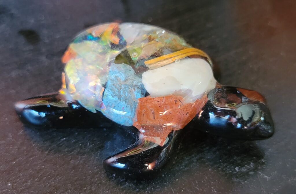 Multicolored glass figurine of turtle.