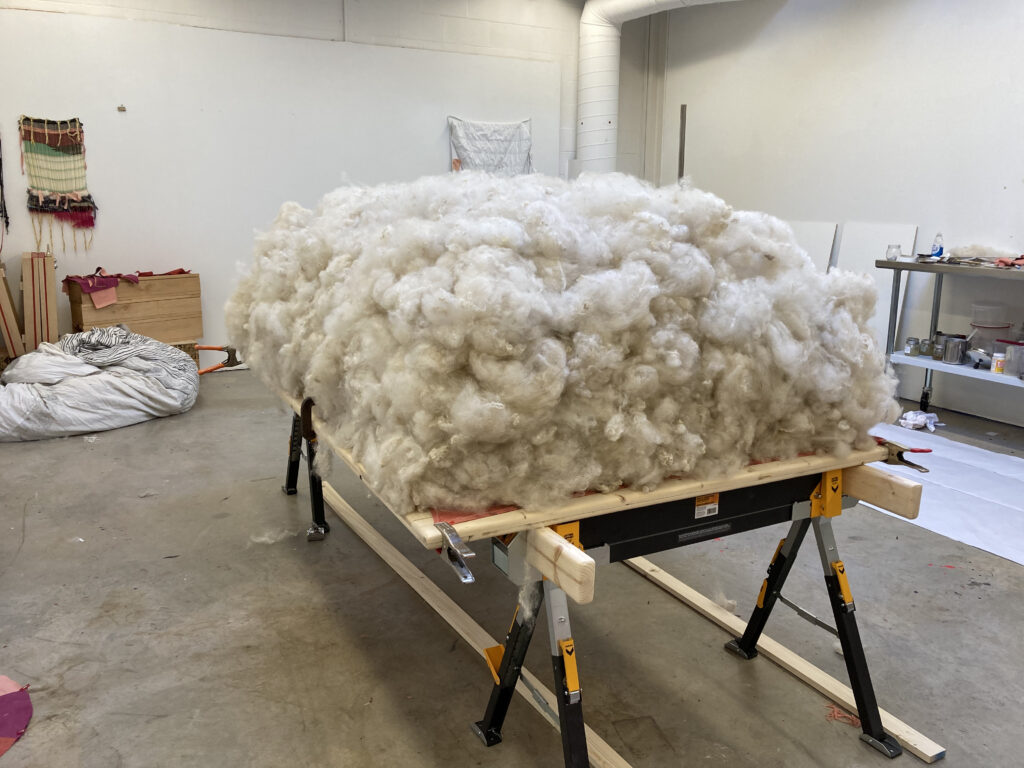 Large pile of wool sits on table.