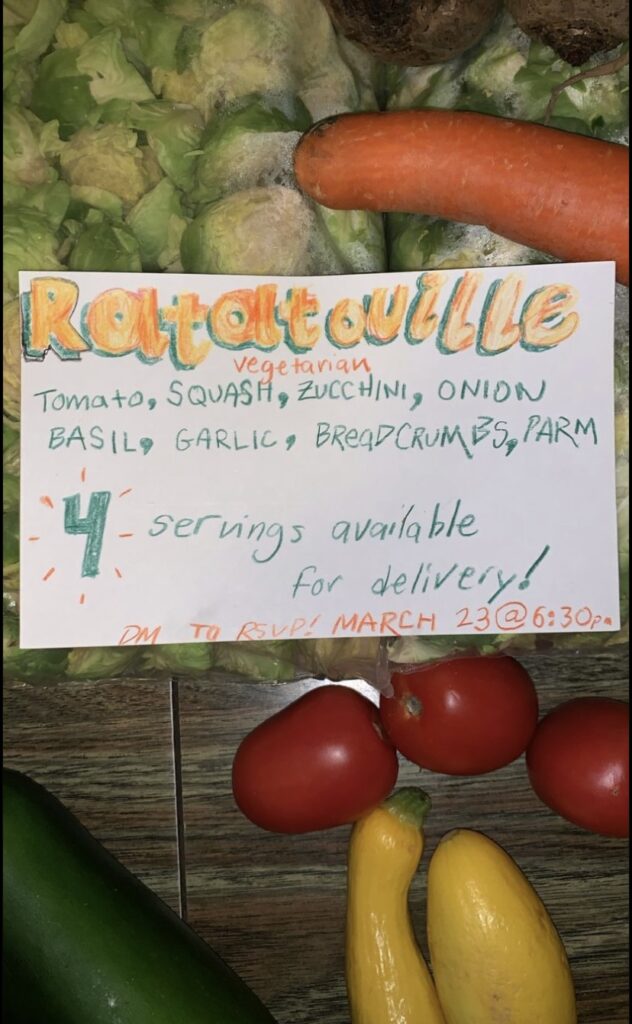 Hand-lettered card with info on ratatouille, laying over raw brussels sprouts, tomatoes, yellow squash, and a carrot.
