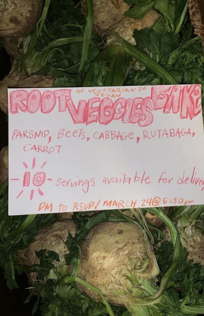 Hand-lettered card with info on root veggies bake, laying over raw rutabagas.