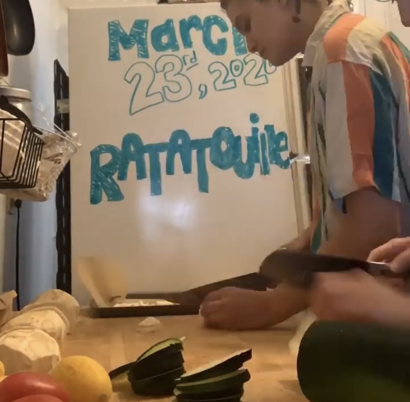 Person slicing vegetables in front of white board reading: March 23, 2020 / RATATOUILLE.
