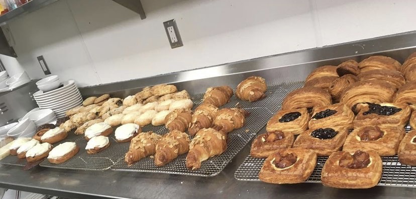 Variety of pastries laid out on cooling racks.