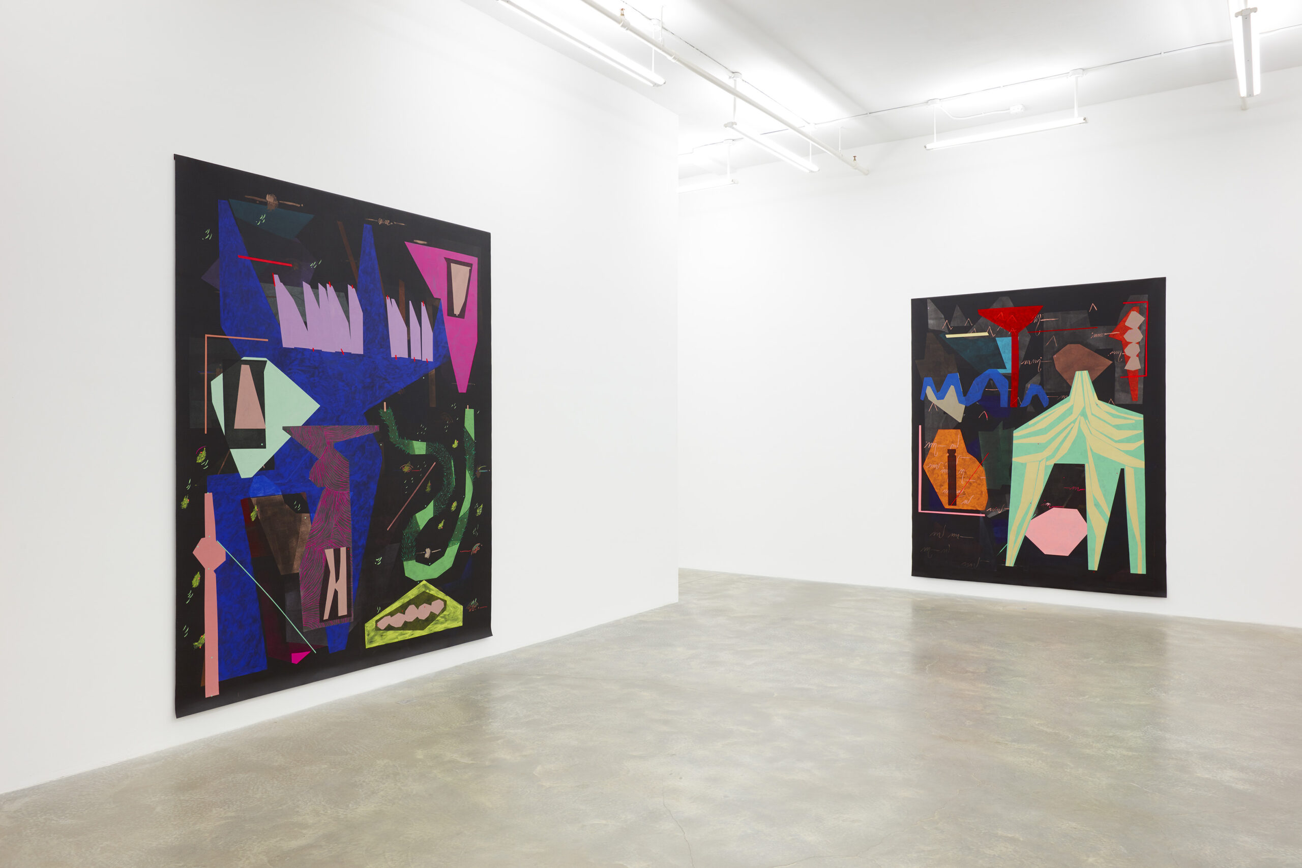 Large white-walled gallery with two large paintings hung on walls, with multicolored abstract shapes on black background.