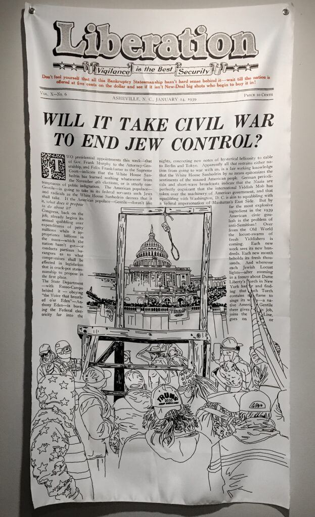 Photo of a satin banner against a white wall, printed like a periodical titled "Liberation" with an illustration of gallows