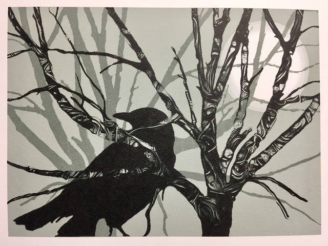 Layered paper cutouts forming crow in branches.