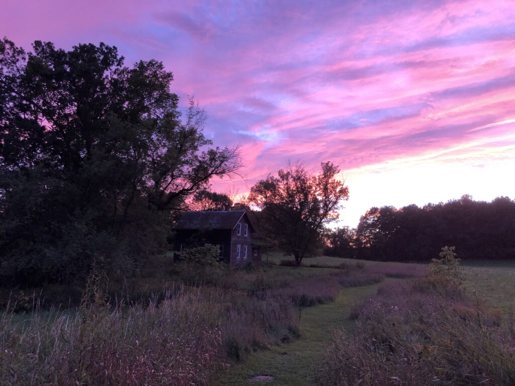 Farmhouse, field, and purple sunset.
