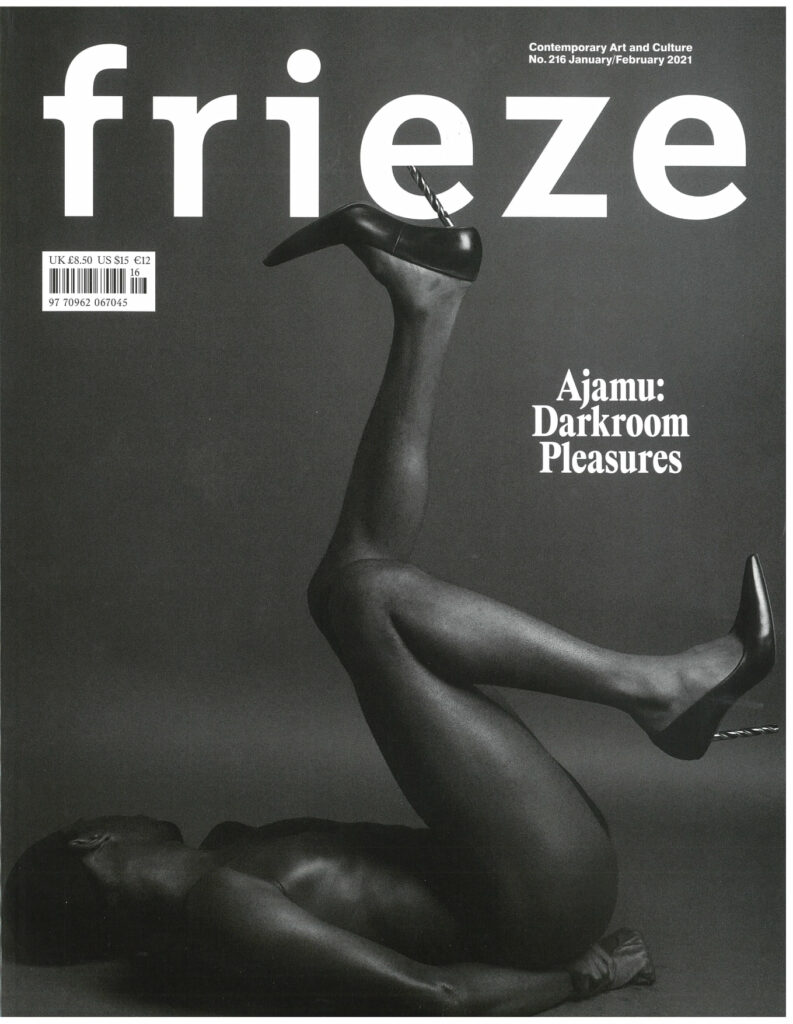Frieze magazine cover with title reading Ajamu: Darkroom Pleasures and black and white photo of person with dark skin and high heels.