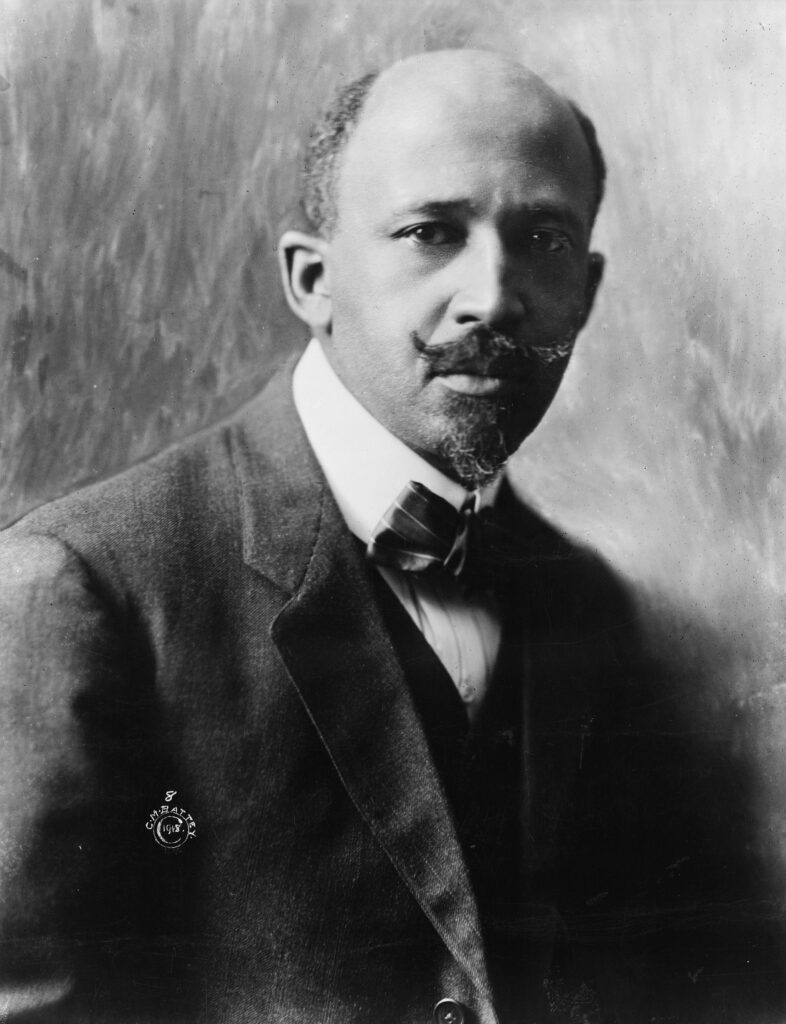 Black and white portrait of man in suit with mustache and goatee