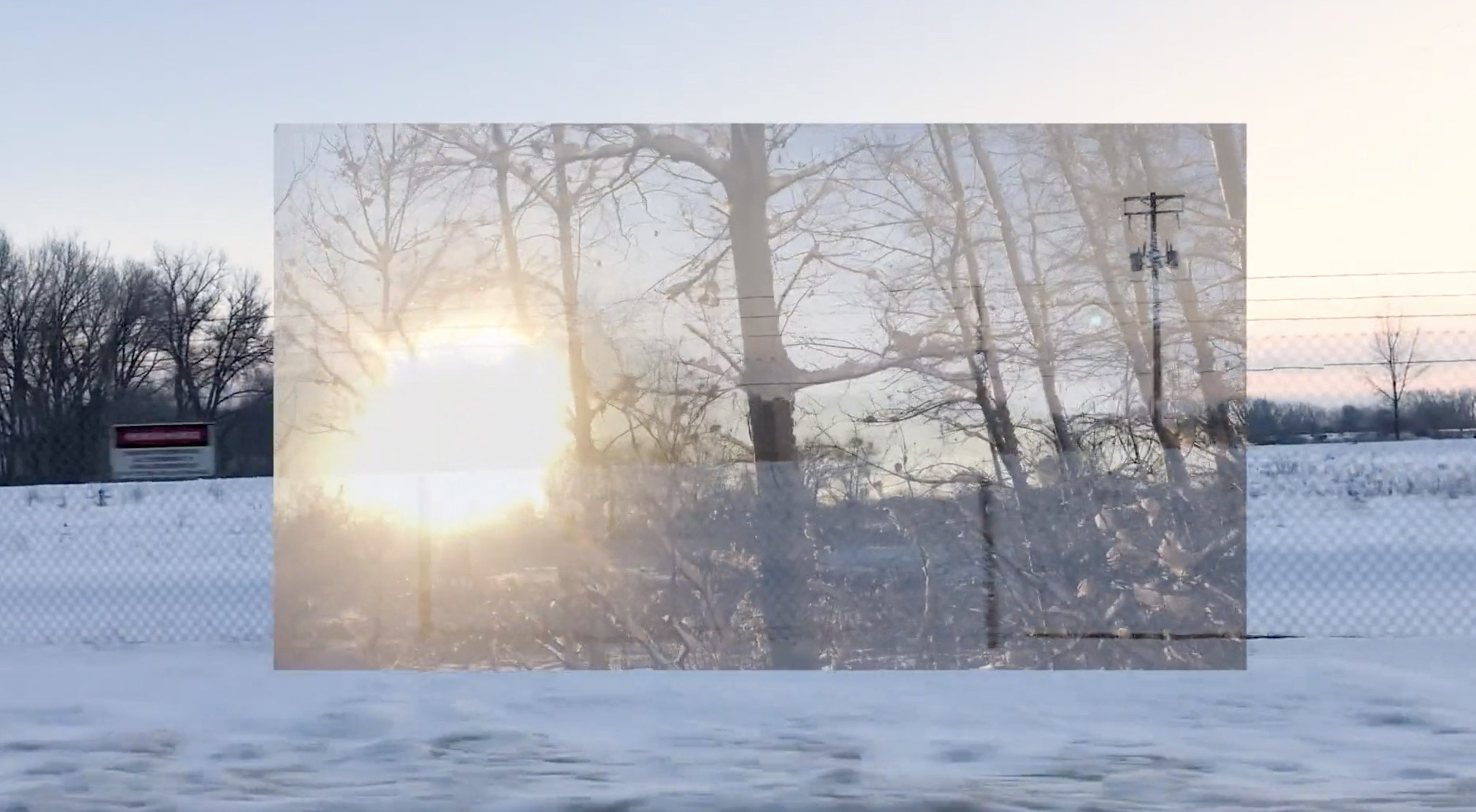 Image of snowy woods and setting sun laid over another image of snowy field.