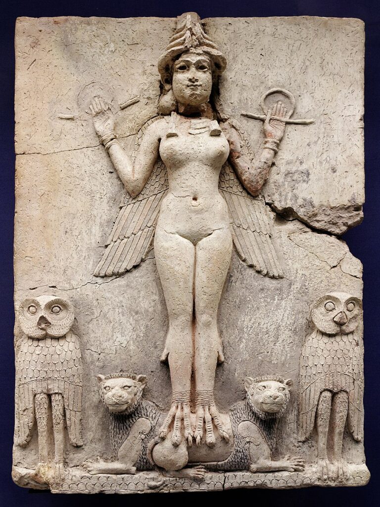Stone relief of female figure with wings, bird feet, standing on two lions, with owls on either side.