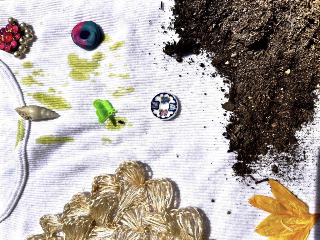 Fag tank, coaster, hair clip, tiny plate, pressed flowers, polymer bead, shell, pendant, soil on white fabric.