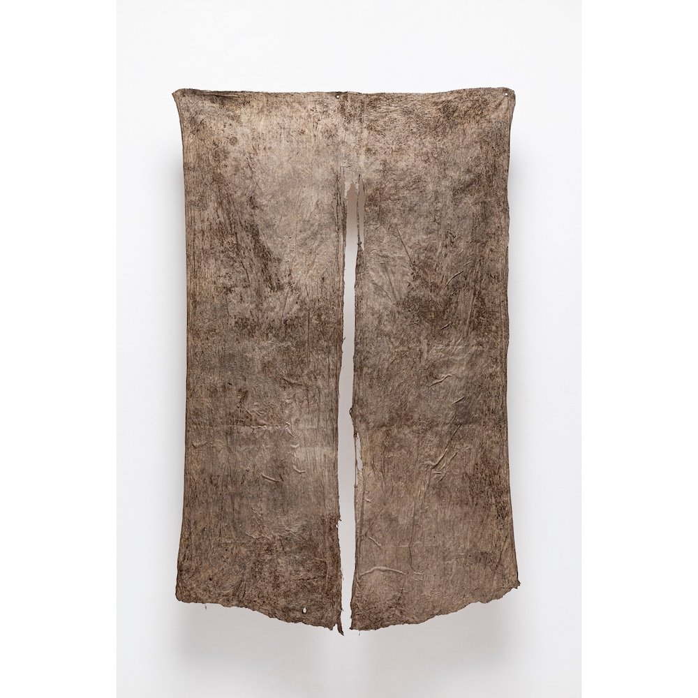 Rectangular brown dyed silk with long slit up the center.