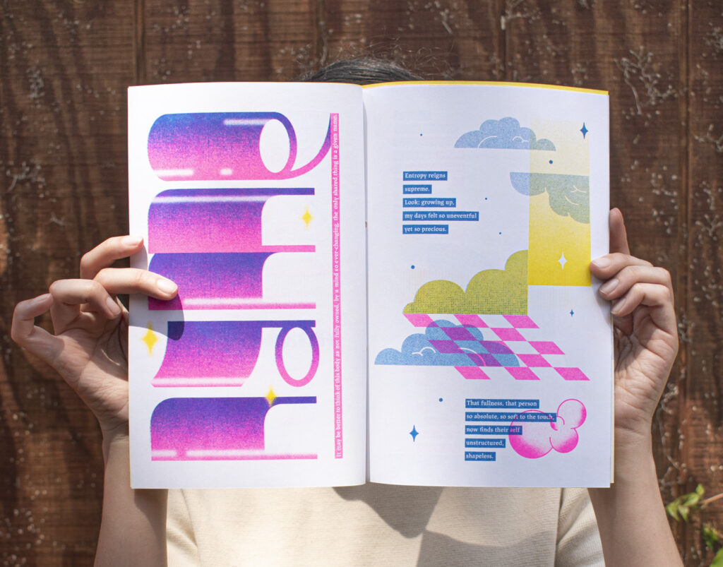 Hands hold printed book with multicolored illustrations.