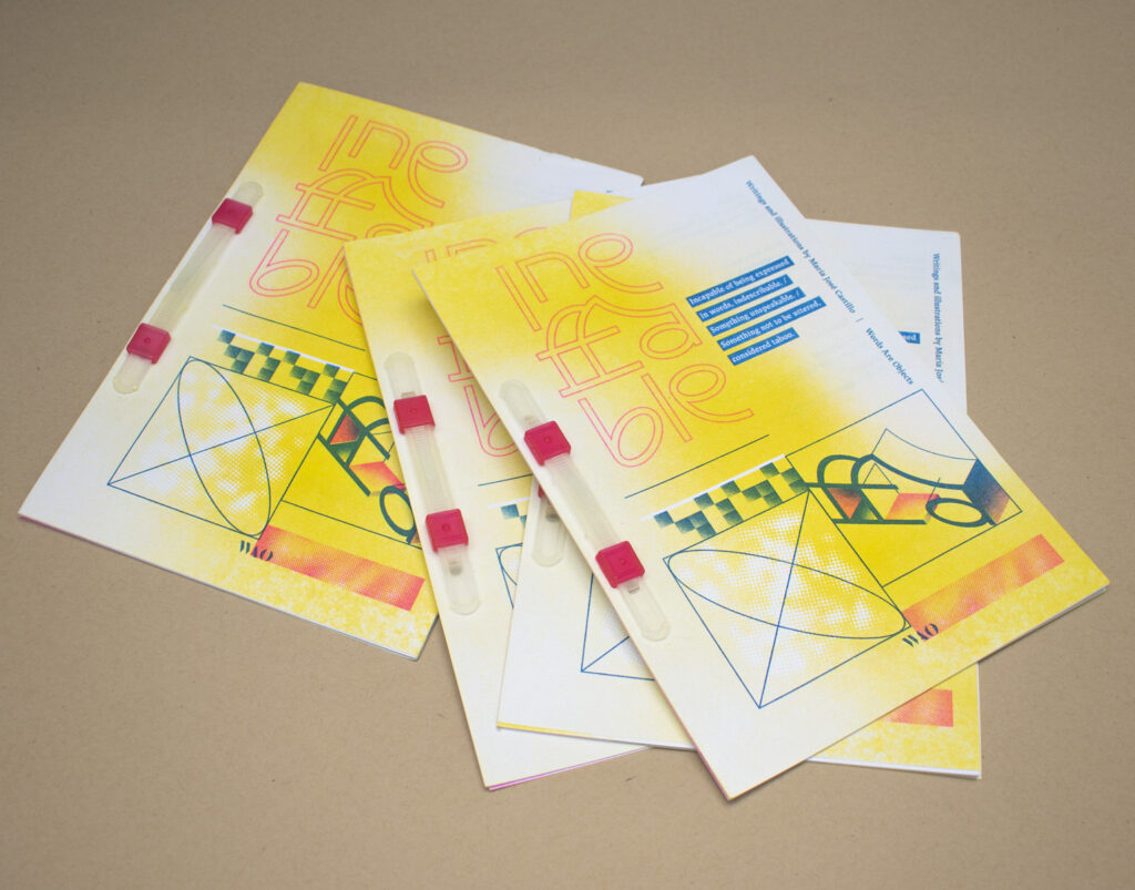 Stack of printed booklets with yellow, red, blue, and green illustration.