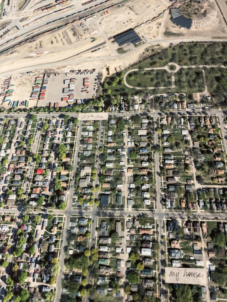 Aerial photograph of neighborhood with adjacent train yard and "my house" label