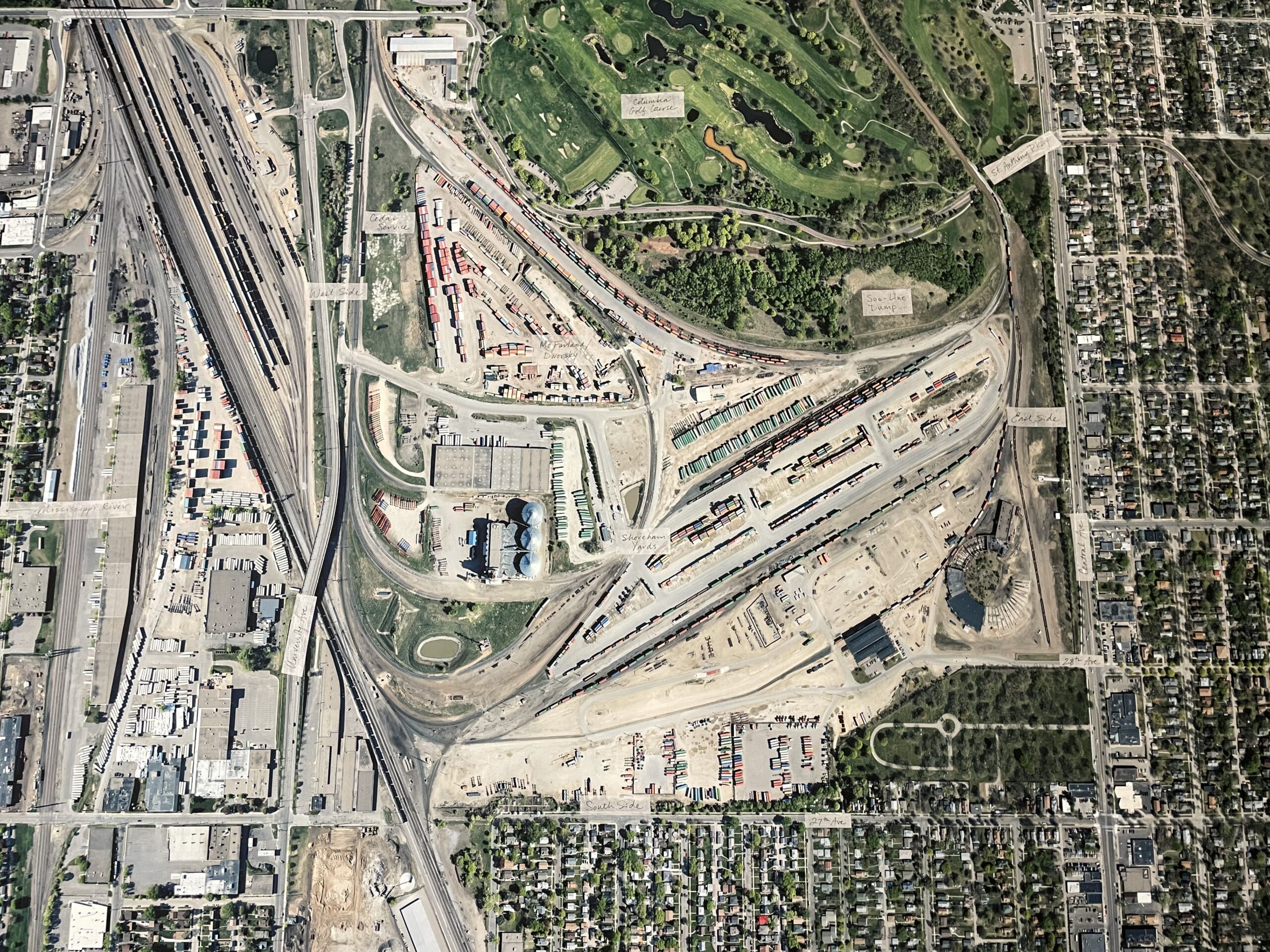 Aerial photograph of train yard with adjacent neighborhoods