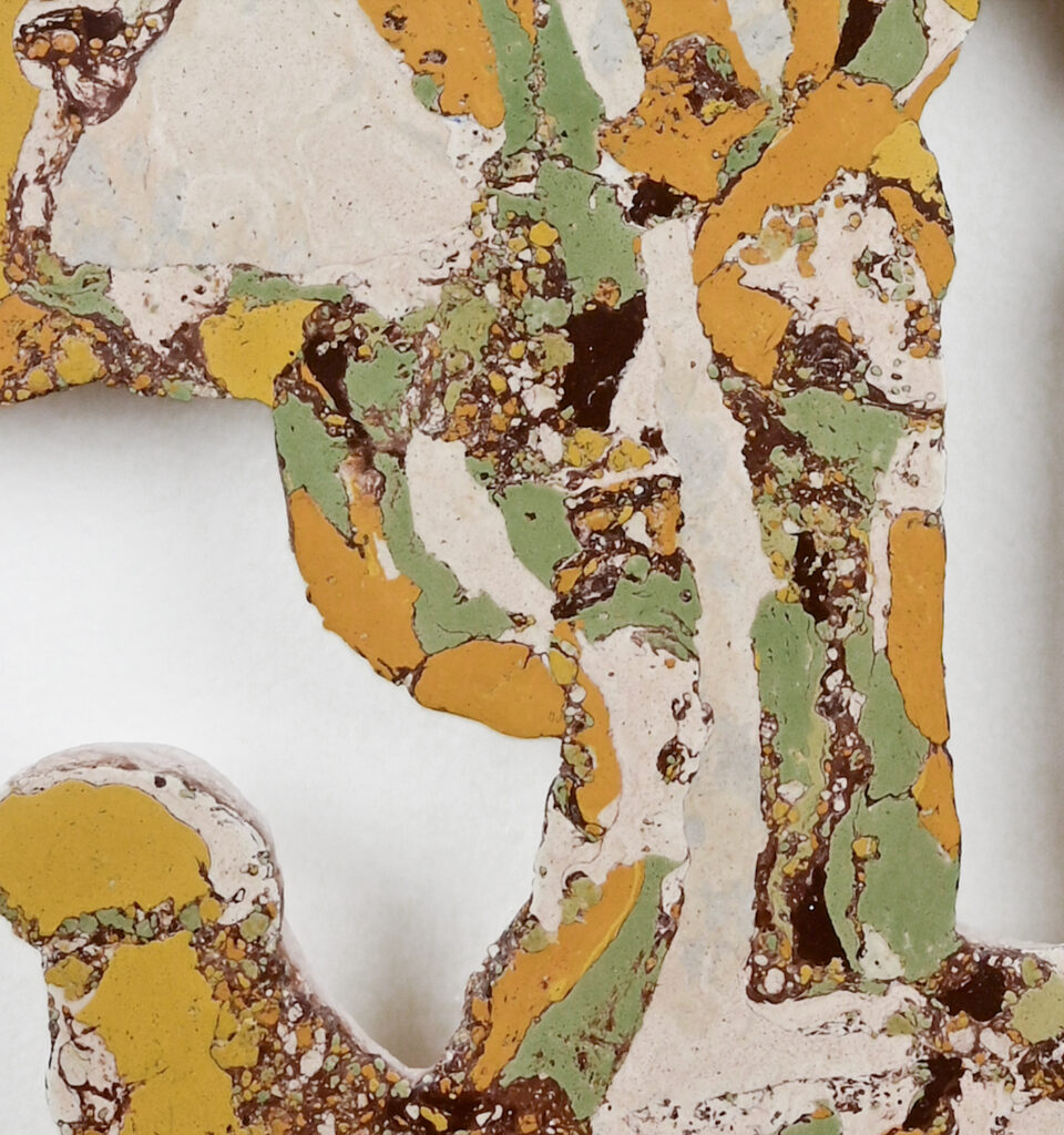 Close up of marbled paint, gold green and white