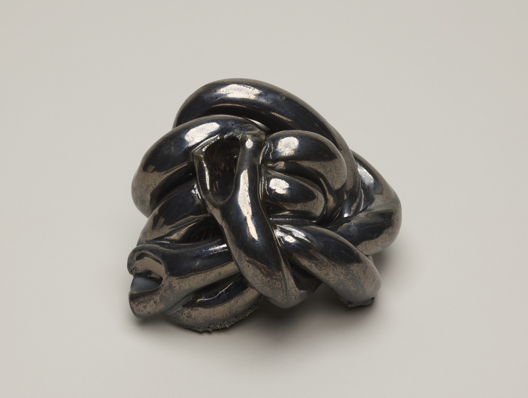 Shiny black clay resembling knotted rope