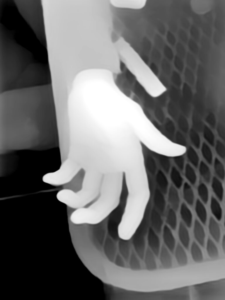 Digital black and white negative of disembodied hand with mesh in background