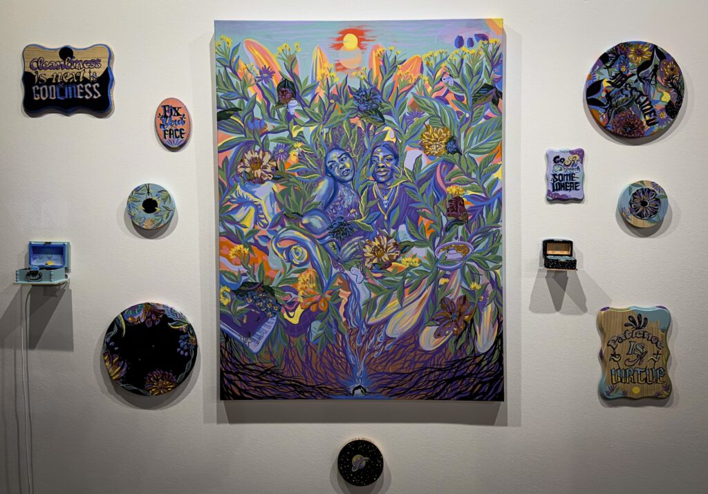 Colorful painting of people and plants surrounded by smaller painted plaques