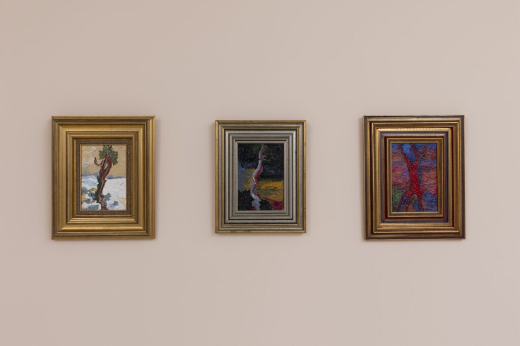 Three small paintings with gold frames, with tree like forms.
