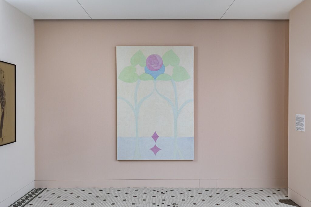Minimal abstract painting of plants in pastel colors, against pale pink gallery wall